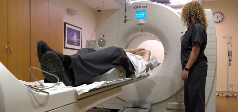 A patient undergoing a coronary calcium scan in a PET/CT system